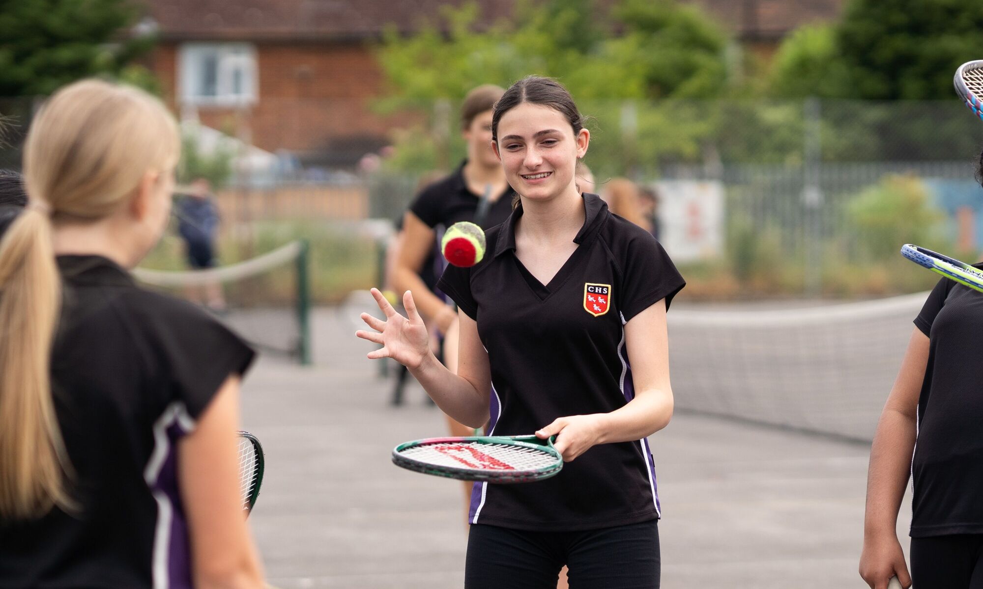 Female with a tennis racket and ball